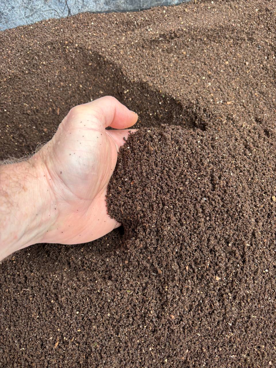Finished worm castings held in hand.